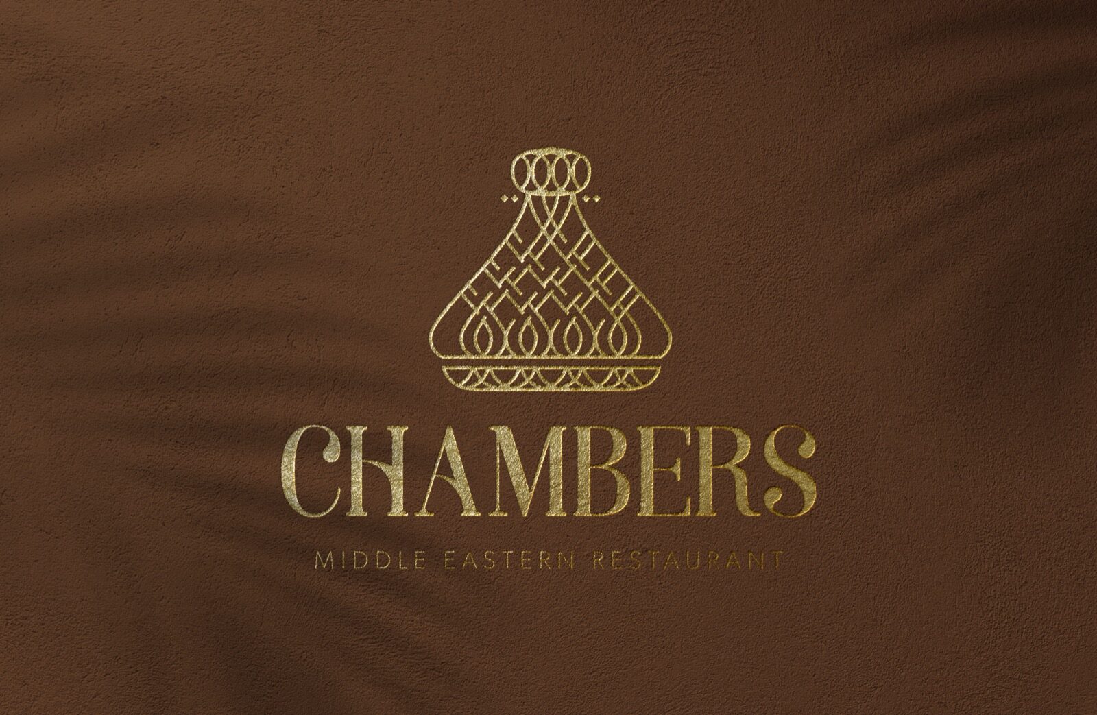 The Chambers logo in gold foil on brown card