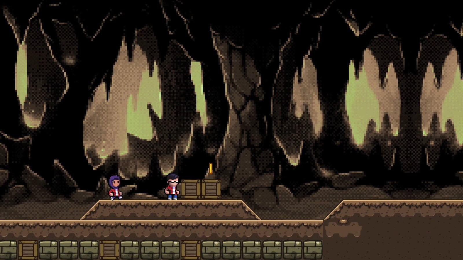 A frame from the video version: the heroes in a dark cave lit by pale green light